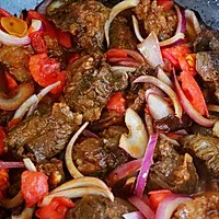 4:Return beef, add spices and hot water, then simmer covered